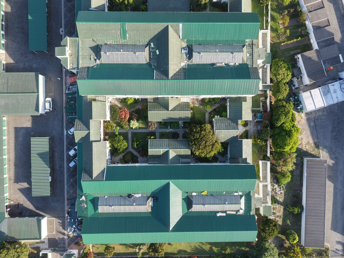 Top-down view of a residential complex with green roofs